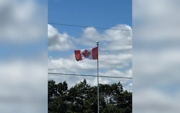 Canadian flag flying over a treeline in Ontario during the Sigrow GrowerDay visit